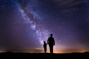 Mother and son under starry sky